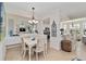 Elegant dining room with a stylish chandelier and adjacent kitchen at 7019 River Hammock Dr # 306, Bradenton, FL 34212