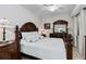 Elegant main bedroom with wood furniture, plush bedding, and serene ambiance at 7019 River Hammock Dr # 306, Bradenton, FL 34212