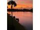 Scenic view of a peaceful pond at sunset, bordered by trees and vibrant colors at 7019 River Hammock Dr # 306, Bradenton, FL 34212