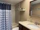 Bathroom featuring a shower-tub combo, neutral tile, vanity with modern sink and dark hardware. Offers a serene, private space at 725 Capri Isles Blvd # 217, Venice, FL 34292