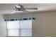 Bedroom with a ceiling fan, large window, and neutral walls at 725 Capri Isles Blvd # 217, Venice, FL 34292