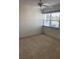 Bedroom features a ceiling fan, a large window, and neutral walls at 725 Capri Isles Blvd # 217, Venice, FL 34292