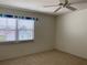 Cozy bedroom featuring neutral carpet, a ceiling fan and bright window, creating a comfortable and inviting space at 725 Capri Isles Blvd # 217, Venice, FL 34292