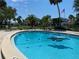 Enjoy this inviting community pool with a playful alligator float and surrounding tropical landscaping at 725 Capri Isles Blvd # 217, Venice, FL 34292