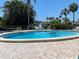Relax by the beautiful community pool, surrounded by lush landscaping and comfortable seating at 725 Capri Isles Blvd # 217, Venice, FL 34292
