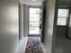 Bright condo entryway features tile floors and open doorway to an adjacent room at 725 Capri Isles Blvd # 217, Venice, FL 34292