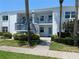 Inviting condo building with well-maintained landscaping, fresh paint, and bright sunny exposure at 725 Capri Isles Blvd # 217, Venice, FL 34292