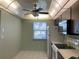 Open kitchen includes an eat-in area, laminate countertops, and modern ceiling fan at 725 Capri Isles Blvd # 217, Venice, FL 34292