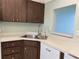 Kitchen view includes sink, dishwasher, and modern laminate countertops at 725 Capri Isles Blvd # 217, Venice, FL 34292