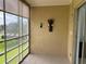 The lanai has tile flooring, vertical blinds, and a decorative wall sconce at 725 Capri Isles Blvd # 217, Venice, FL 34292