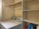 Laundry room with washer, dryer, storage shelves, and neutral paint at 725 Capri Isles Blvd # 217, Venice, FL 34292