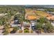 Aerial view of home near baseball field and bay, surrounded by beautiful trees and landscaping at 7508 9Th N Ave, St Petersburg, FL 33710