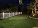 Backyard putting green with white picket fence and landscaped borders at 7508 9Th N Ave, St Petersburg, FL 33710