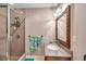 Clean bathroom with glass shower and framed mirror over vanity with granite countertop at 7508 9Th N Ave, St Petersburg, FL 33710