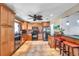 Well-lit kitchen with wood cabinets, stainless steel appliances, and a breakfast bar at 7508 9Th N Ave, St Petersburg, FL 33710