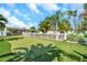 Backyard putting green with lush landscaping, bordered by a white picket fence at 7508 9Th N Ave, St Petersburg, FL 33710
