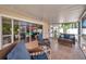 Relaxing screened patio with tiled floor, comfortable seating, and peaceful outdoor views at 7508 9Th N Ave, St Petersburg, FL 33710
