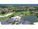 Aerial view of the home showing its pool, golf course and water views at 7728 Club Ln, Sarasota, FL 34238