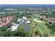 Aerial view of the house with stunning golf course and water views, showcasing the community's desirable location at 7728 Club Ln, Sarasota, FL 34238