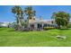 The backyard features a well-maintained lawn with an enclosed lanai, perfect for relaxing outdoors at 7728 Club Ln, Sarasota, FL 34238