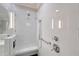 Modern tiled walk-in shower with a built-in seat, enhanced by sleek, adjustable shower heads at 7728 Club Ln, Sarasota, FL 34238