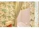 Bathtub and patterned wall paper and shower curtain at 7728 Club Ln, Sarasota, FL 34238