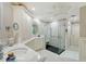 Bathroom featuring a modern walk-in shower, elegant vanities, and classic white tile flooring at 7728 Club Ln, Sarasota, FL 34238