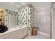 Bathroom featuring patterned wallpaper and walk-in shower at 7728 Club Ln, Sarasota, FL 34238