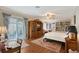 Spacious bedroom with built-in shelving, a ceiling fan, and access to a sunroom at 7728 Club Ln, Sarasota, FL 34238