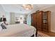 Comfortable bedroom with a four-poster bed, built-in storage, and large windows at 7728 Club Ln, Sarasota, FL 34238