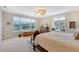 Bright bedroom with lake view, ceiling fan, and carpeted floors at 7728 Club Ln, Sarasota, FL 34238