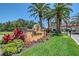 Prestancia entrance with lush landscaping, flowers, and a guard house at 7728 Club Ln, Sarasota, FL 34238
