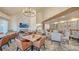 Beautiful dining room with a decorative chandelier, tables and chairs, and large windows overlooking the grounds at 7728 Club Ln, Sarasota, FL 34238