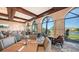 Elegant dining room featuring large arched windows with golf course views and modern furnishings at 7728 Club Ln, Sarasota, FL 34238