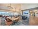 Spacious dining area with contemporary lighting and ample seating, ideal for gatherings and enjoying meals with a view at 7728 Club Ln, Sarasota, FL 34238