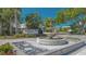 Entrance to The Enclave features a lovely water fountain surrounded by lush landscaping at 7728 Club Ln, Sarasota, FL 34238