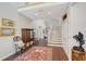 Elegant foyer featuring hardwood floors, staircase and classic decor at 7728 Club Ln, Sarasota, FL 34238
