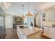 Bright kitchen featuring an island with granite countertops and pendant lighting at 7728 Club Ln, Sarasota, FL 34238