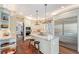 Modern kitchen with stainless steel appliances, a center island, and stylish bar stools at 7728 Club Ln, Sarasota, FL 34238