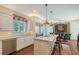 Island kitchen with a stainless steel refrigerator, granite countertop, and eat-in seating at 7728 Club Ln, Sarasota, FL 34238