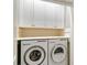 Laundry room with washer, dryer, and cabinets at 7728 Club Ln, Sarasota, FL 34238