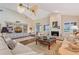 Bright living room featuring a fireplace, wood floors, and vaulted ceiling at 7728 Club Ln, Sarasota, FL 34238