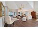 Bright living room with wood floors, fireplace, and comfortable seating arrangements at 7728 Club Ln, Sarasota, FL 34238