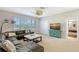 Cozy living room with a large window with great views, comfortable seating, and a coastal-themed media cabinet at 7728 Club Ln, Sarasota, FL 34238