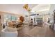 Spacious living room with hardwood floors, vaulted ceiling, and comfortable seating at 7728 Club Ln, Sarasota, FL 34238
