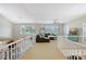 Upstairs loft area with bright windows provides additional living space in this beautifully designed home at 7728 Club Ln, Sarasota, FL 34238