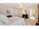 Main bedroom offering a calming color scheme, a fan, and a glimpse into the en-suite bathroom at 7728 Club Ln, Sarasota, FL 34238