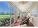 Spacious sunroom featuring lush golf course views and comfortable patio furniture at 7728 Club Ln, Sarasota, FL 34238