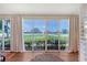 Bright sunroom with sliding glass doors showcasing views of the well-maintained golf course at 7728 Club Ln, Sarasota, FL 34238