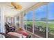 Relaxing sunroom featuring wood floors and large glass windows offering scenic views at 7728 Club Ln, Sarasota, FL 34238